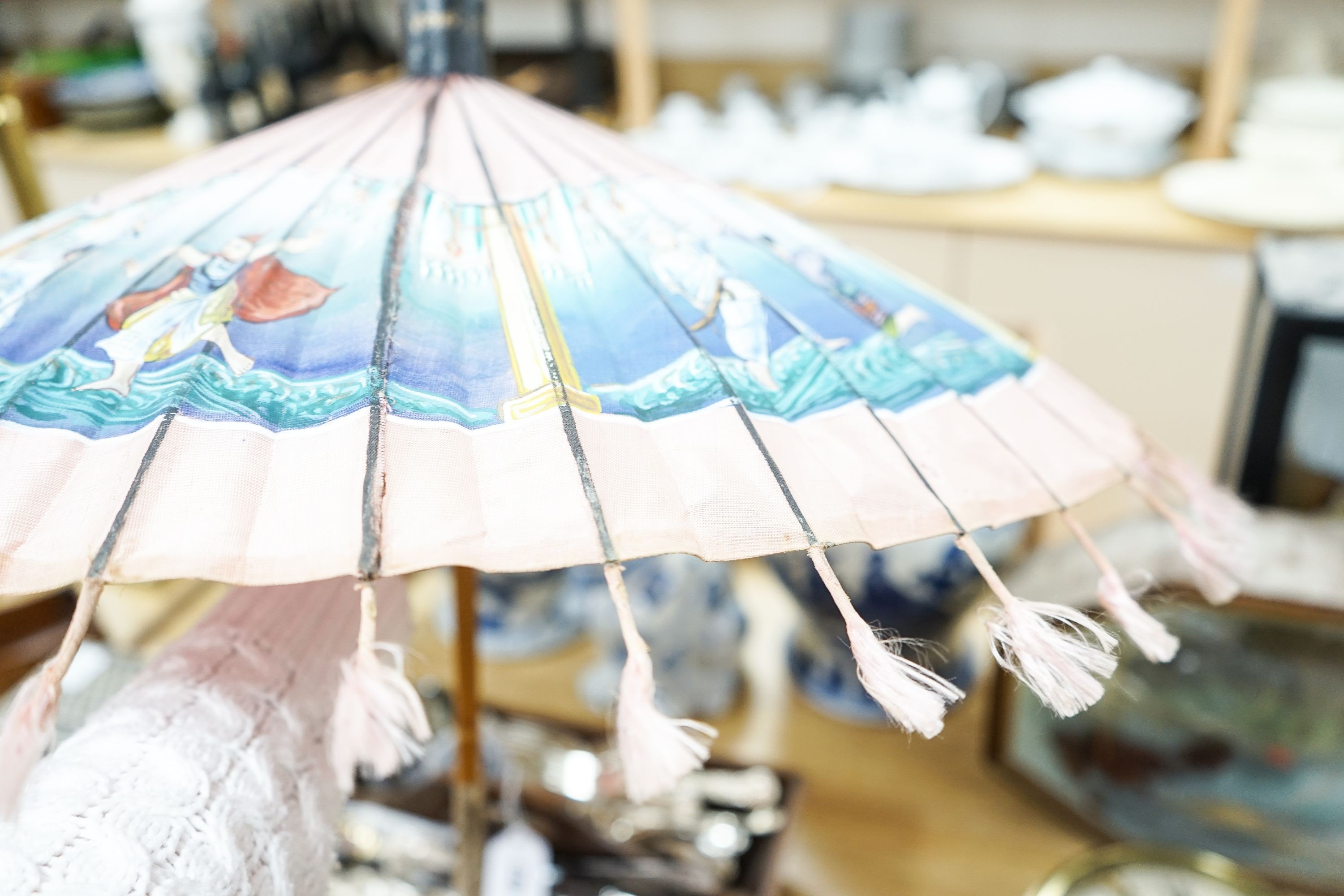A 19th century Chinese Canton export ivory parasol with carved Ivory handle and a Burmese white metal handled painted fabric parasol